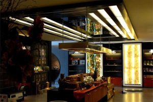 書(shū)店售賣(mài)區(qū)域茶葉裝修效果圖鎏金金屬暗色中式風(fēng)店鋪裝修